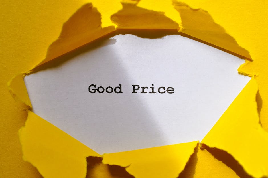 A torn yellow paper background revealing a white surface with the words 'Good Price' printed in black. The torn edges of the paper create a dynamic, textured look around the message, suggesting afford